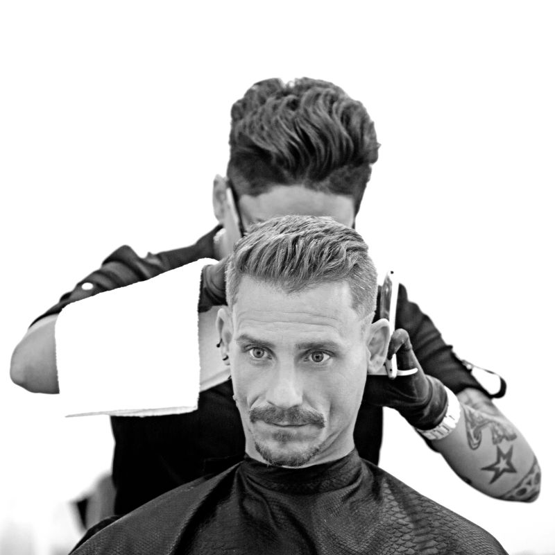 Female barber woman styling attractive moustachioed male client