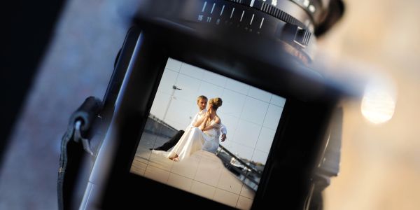 A couple seen through a camera viewfinder.