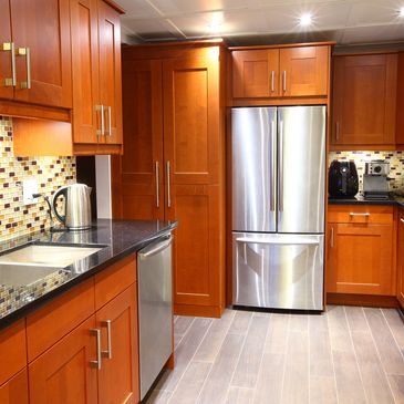 Modern kitchen with wooden cabinets and stainless steel appliances.