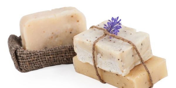 Natural handmade soap bars with a lavender flower on top.