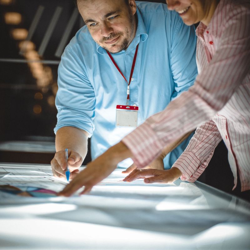 people on the blue print table
