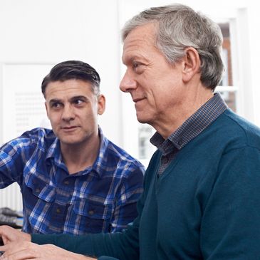 Two men working or discussing something together.
