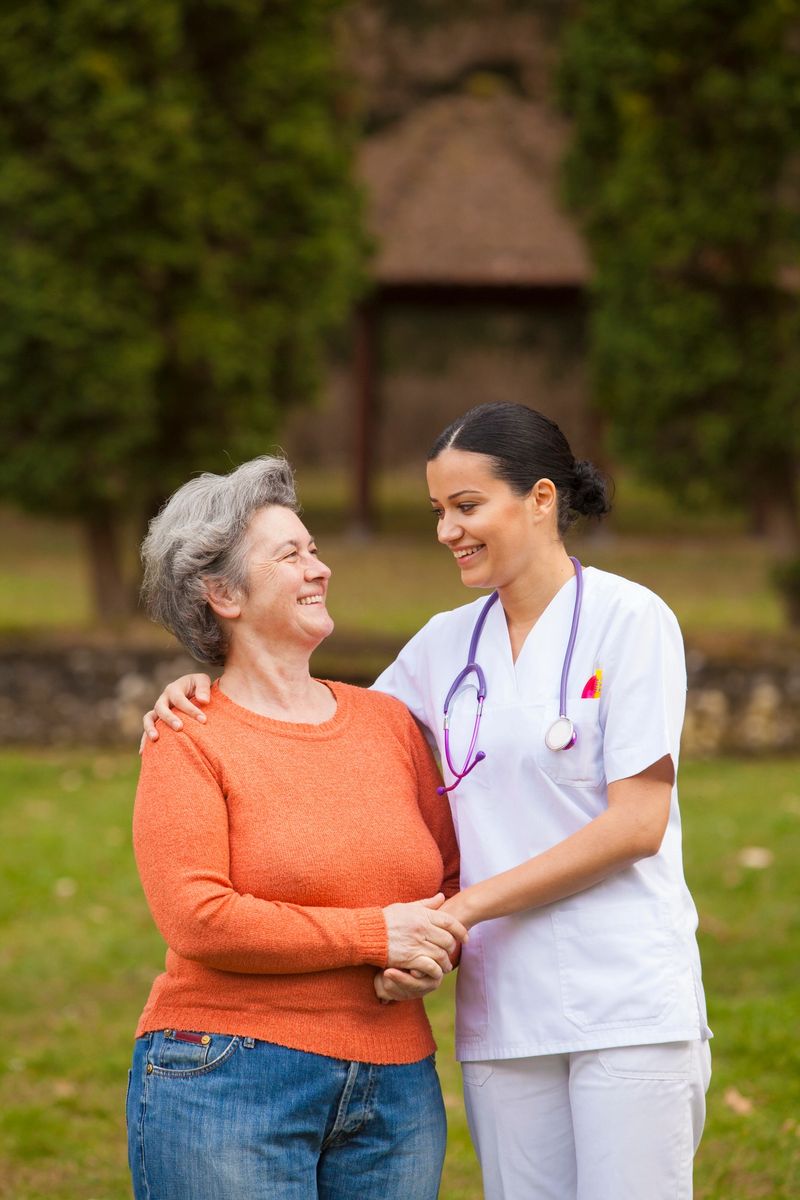 Female nurse and senior woman talking