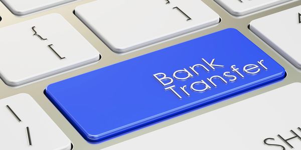Close-up of a keyboard with a blue key labeled 'Bank Transfer'.