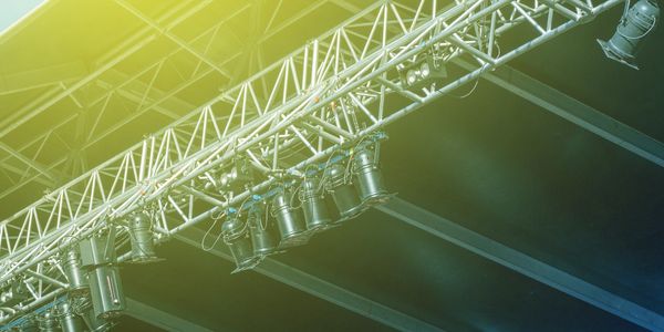 Stage lighting fixtures arranged on overhead trusses.