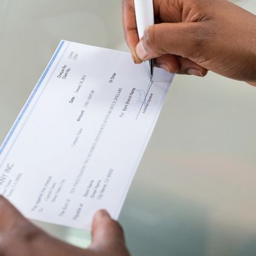 Person signing a check.