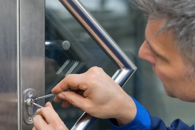 Commercial Locksmith repair tech working on door