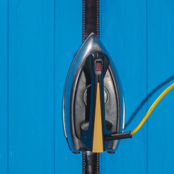Top view of an iron on a blue surface.