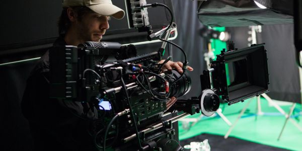 Cinematographer operating professional camera equipment.