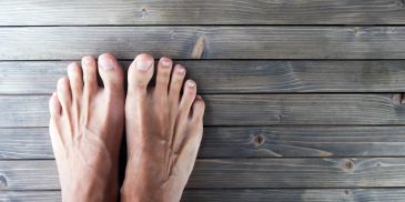 Bare feet on wooden floor.