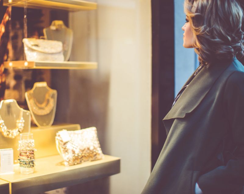 Beautiful young woman looking at jewelry