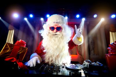Santa DJ with heart-shaped glasses at the turntables.
