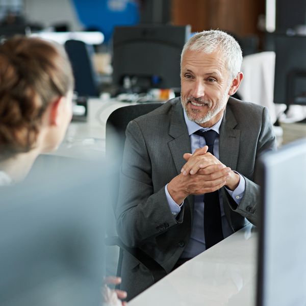 Businessman in a suit engaging in a meeting with a colleague.