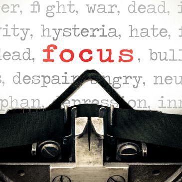 Typewriter highlighting the word 'focus' in red among negative words.
