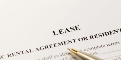 Close-up of a lease agreement document with a pen.