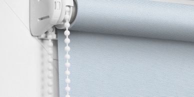 Close-up of a roller blind mechanism with a pull chain.
