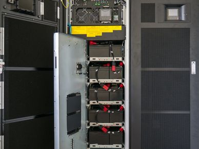 Open server rack showing internal hardware components and cabling.