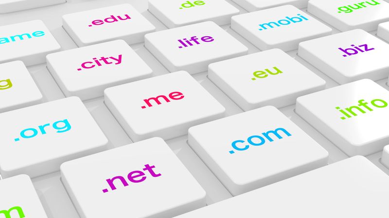 White computer keyboard with differently colored domain endings 3D illustration