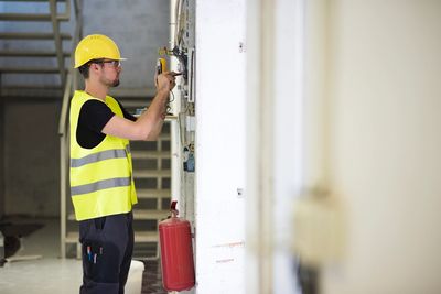 Fire-safety engineer carrying out a routine alarm system check.