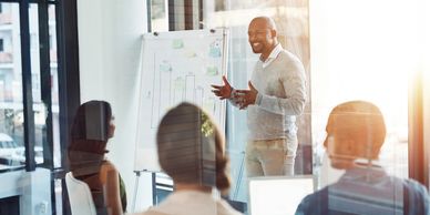 Businessman presenting data to colleagues in an office meeting.