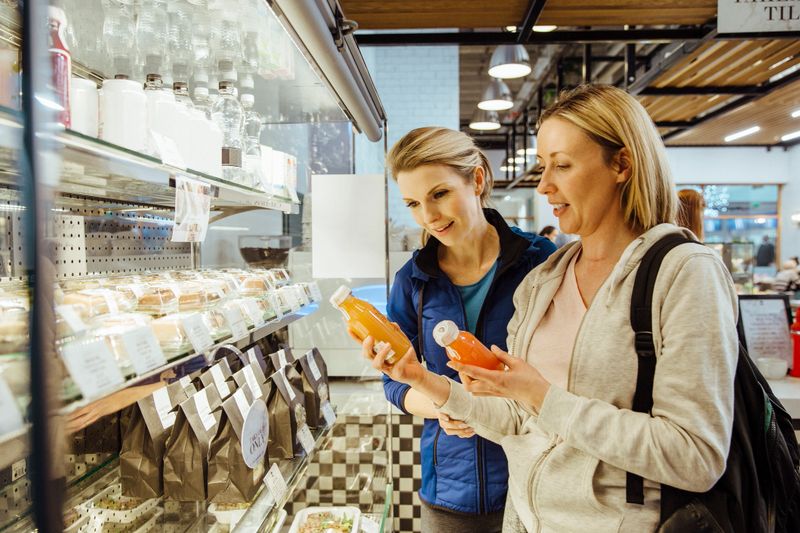 Women comparing antioxidant bevarages in a health cafe after working out.