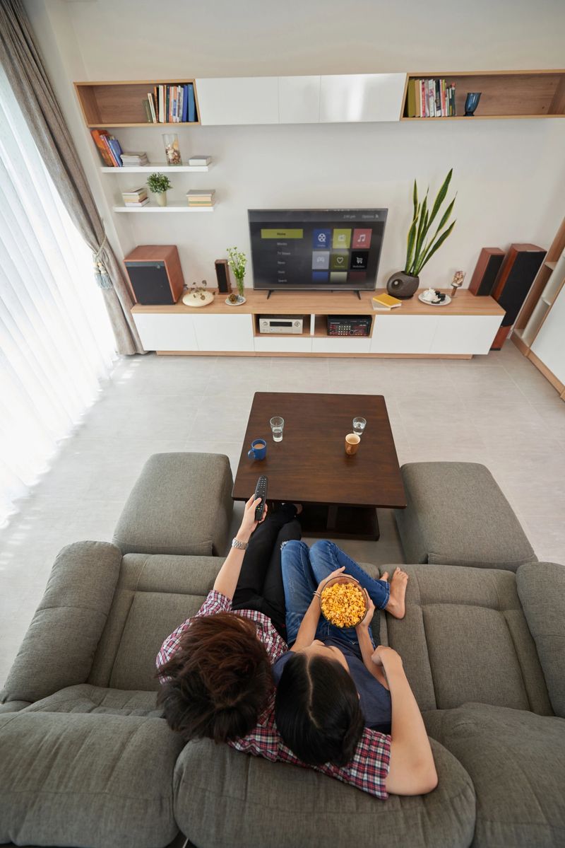 Couple watching smart tv, view from above