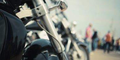 Close-up of a motorcycle parked in a row.