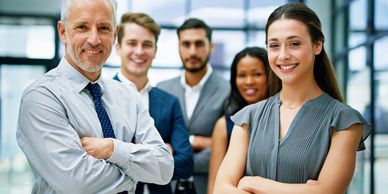 Confident diverse business team posing with crossed arms in a modern office.