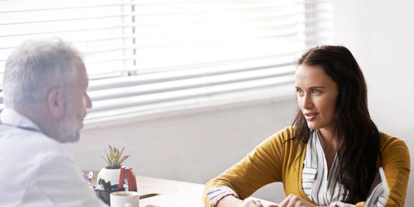 A woman is consulting with a bioidentical hormone prescribing doctor regarding her hormone symptoms