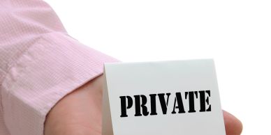 Hand holding a card with 'PRIVATE' text.