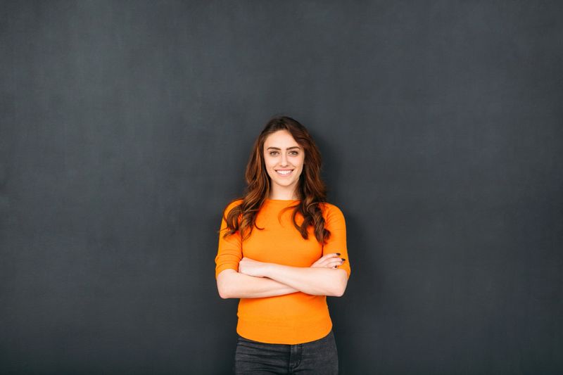 Woman standing in front of a blackboard.