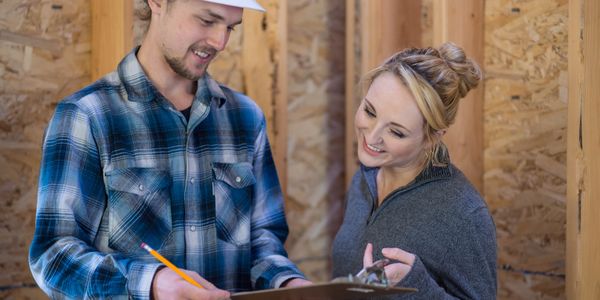 Contractor reviewing restoration documents with a homeowner.