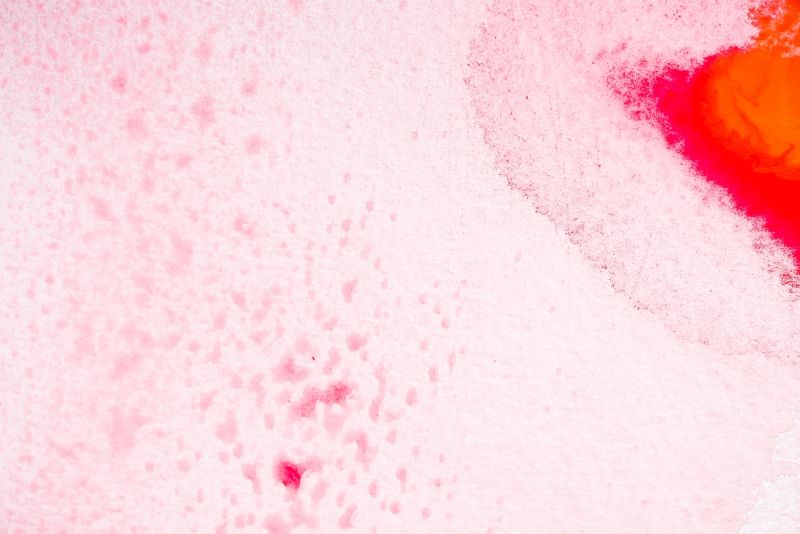 Watercolor splashes and stains on paper. Macro top view