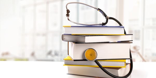 Stack of books with a stethoscope.