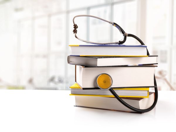 Stack of books with a stethoscope.
