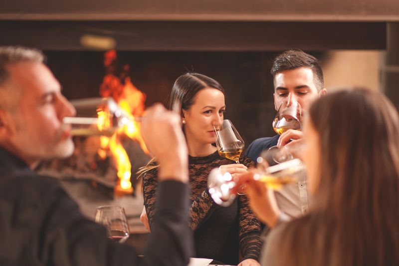 Joyful moments of a small group of Friends at Dinner in Restaurant