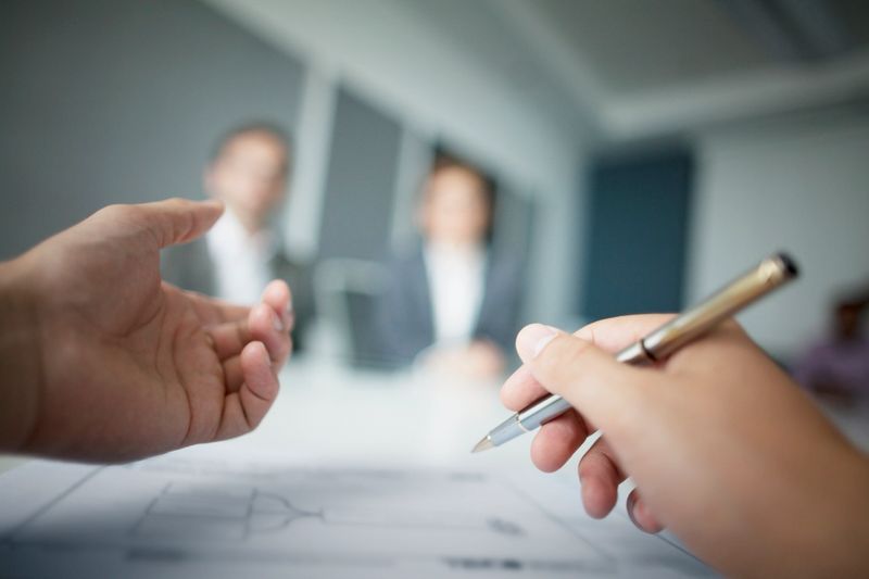 Close-up of hands gesturing during business meeting in office