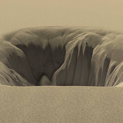 A deep sand sinkhole with smooth, flowing edges in a desert.