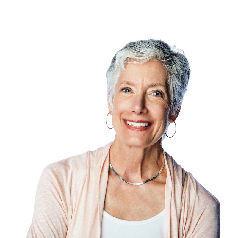 Studio portrait of a happy senior woman posing against a white background
