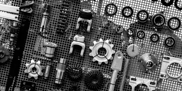 Various mechanical parts organized on a grid surface.