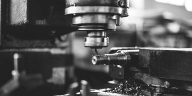 Black and white image of a milling machine in action.