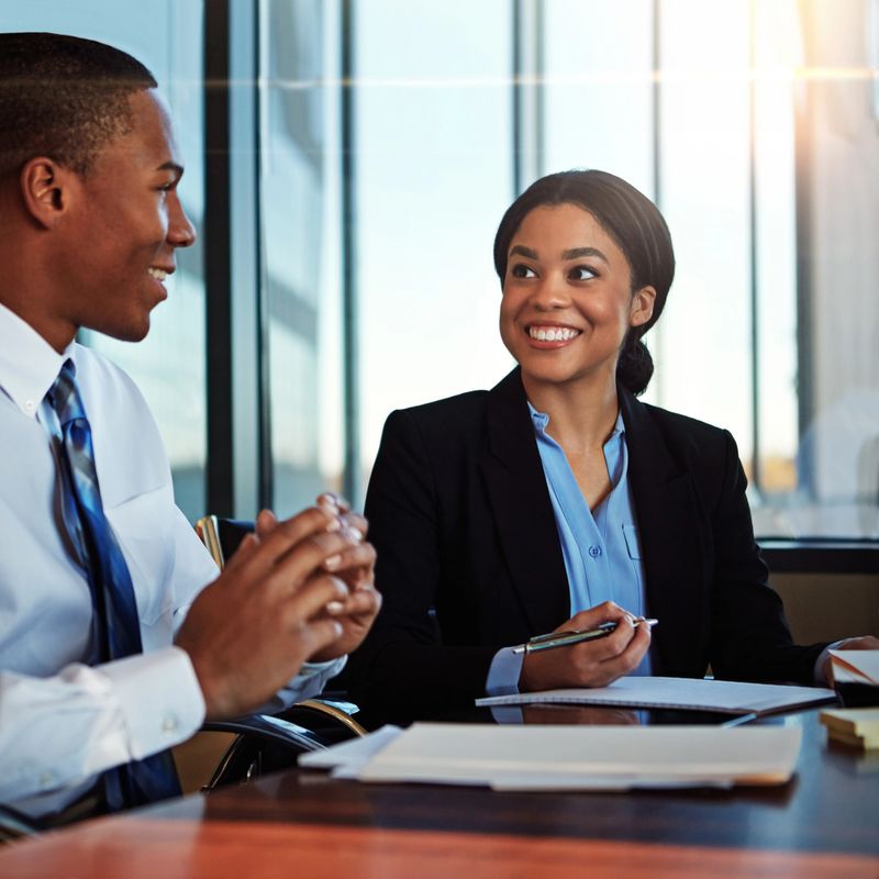 Cropped shot of two young businesspeople meeting in the boardroom