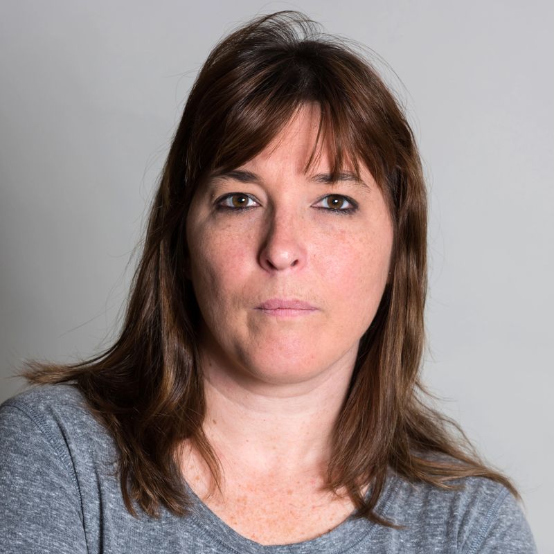 Serious caucasian mature woman posing on gray background