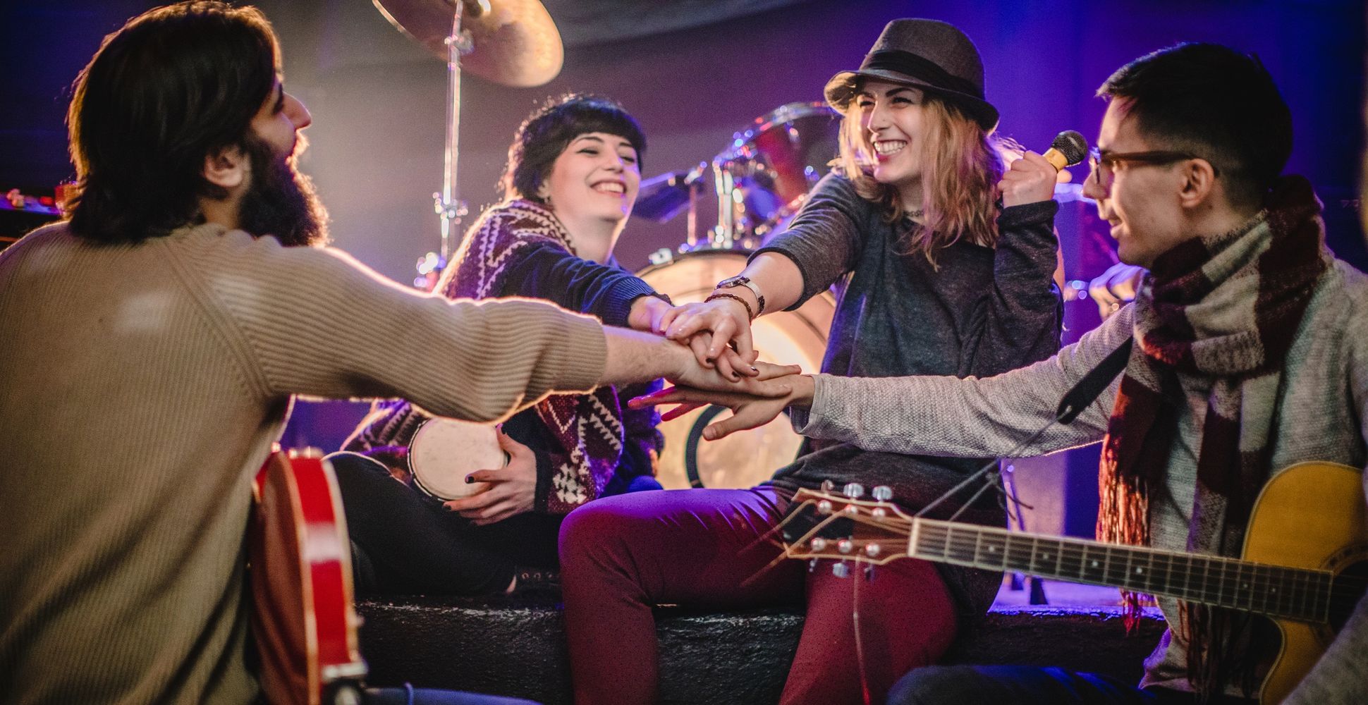 Three colleagues attentively looking at a laptop screen in a modern office.