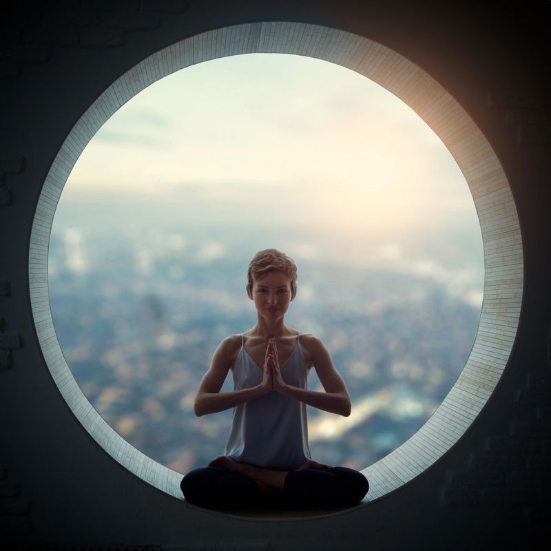young woman doing yoga in the round window