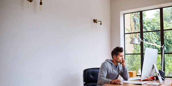 image of a professional working from his beautiful home office with view of a nature 