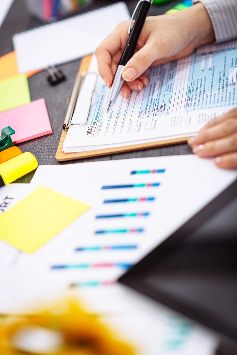 Businesswoman filling out tax form in office