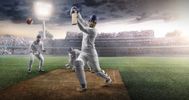 Cricketer hitting a six in a stadium under bright lights.