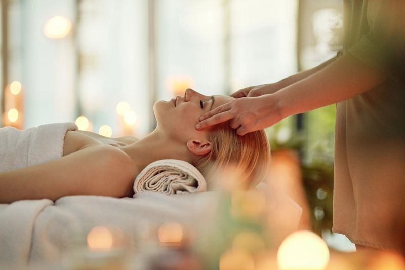 Cropped shot of a young woman enjoying a head massage at a spa