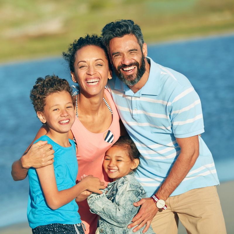 Shot of a family of four enjoying a day at the beach